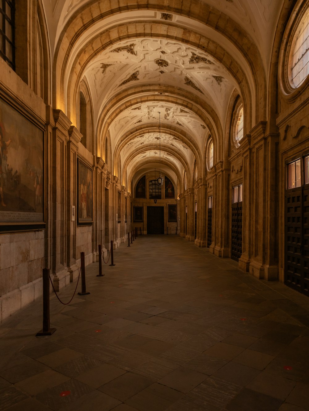 a long hallway with a painting on the wall