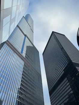 a couple of tall buildings sitting next to each other