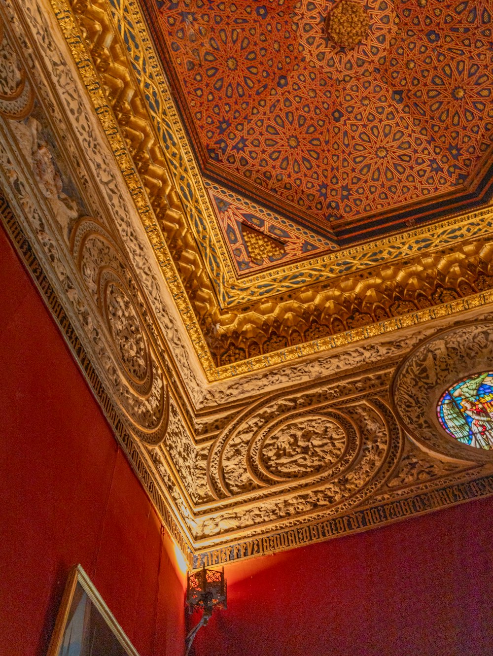 the ceiling of a room with a stained glass window