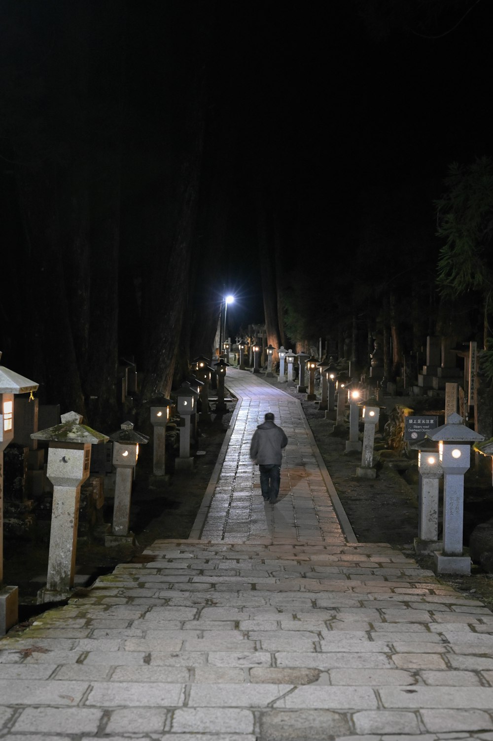 a man walking down a street at night