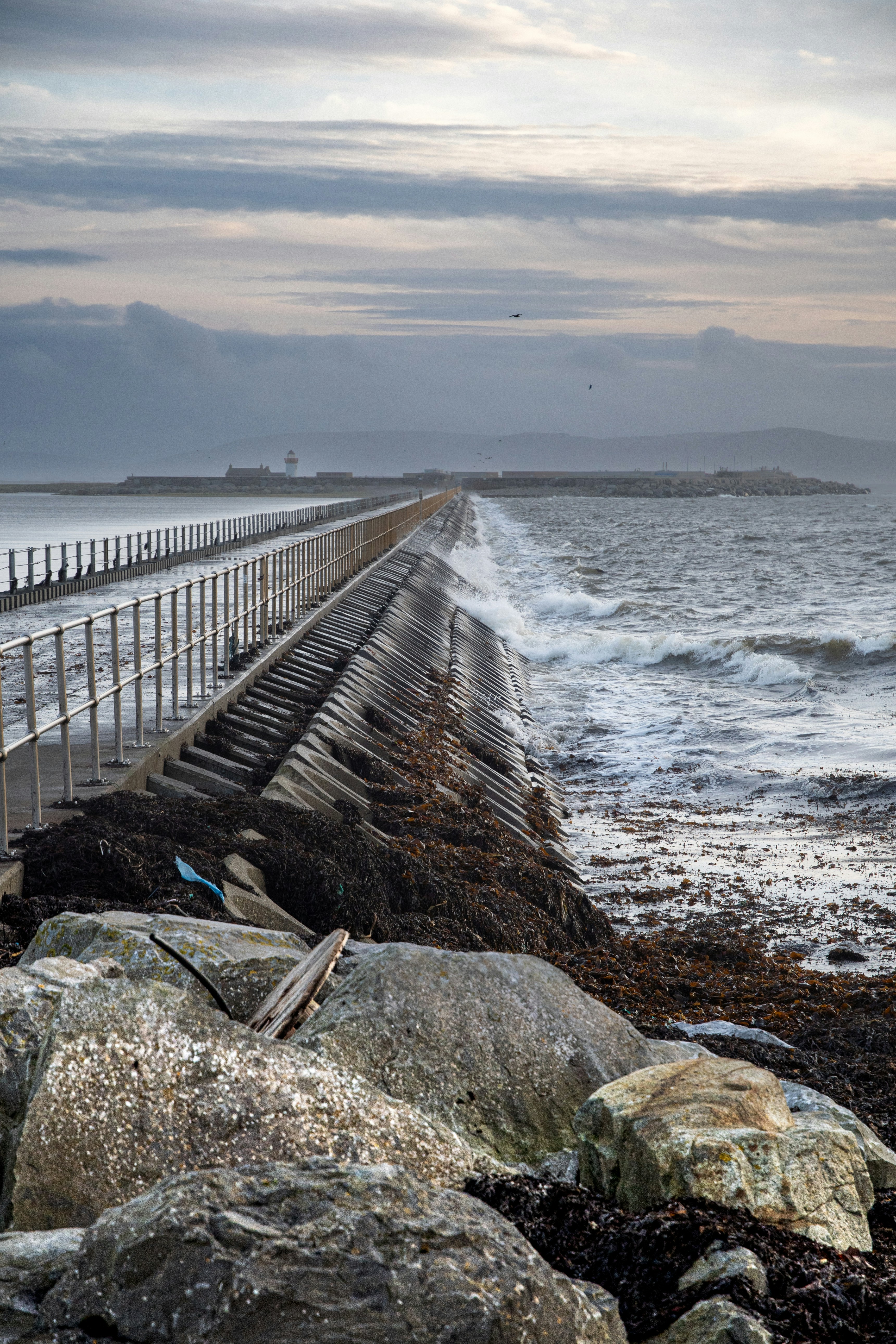 a large body of water sitting next to a rocky shore