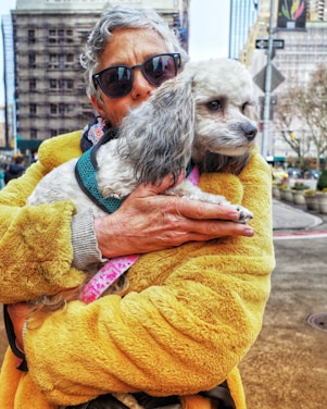 a woman holding a dog in her arms