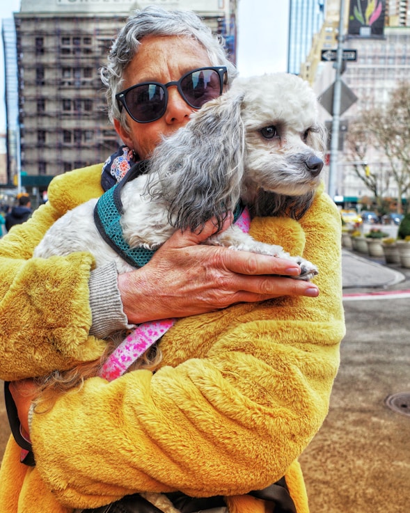 a woman holding a dog in her arms