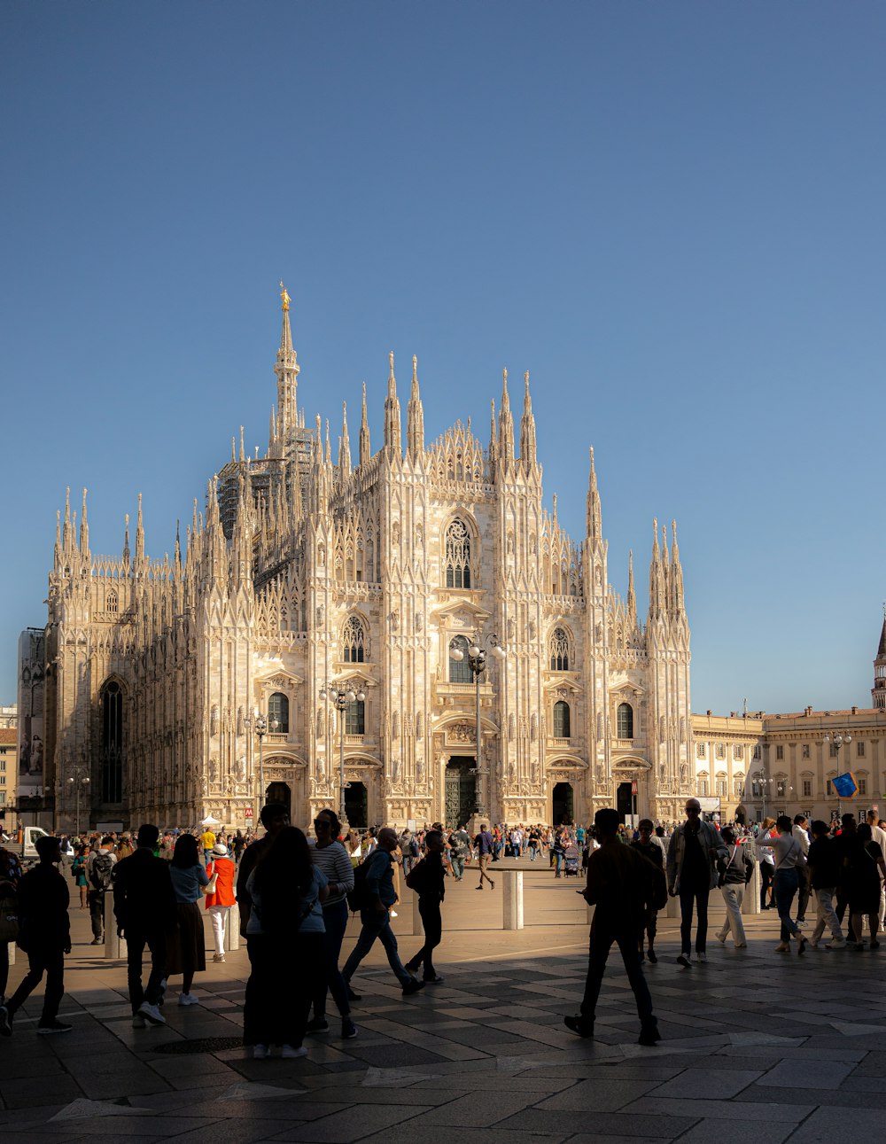 a group of people standing in front of a large building