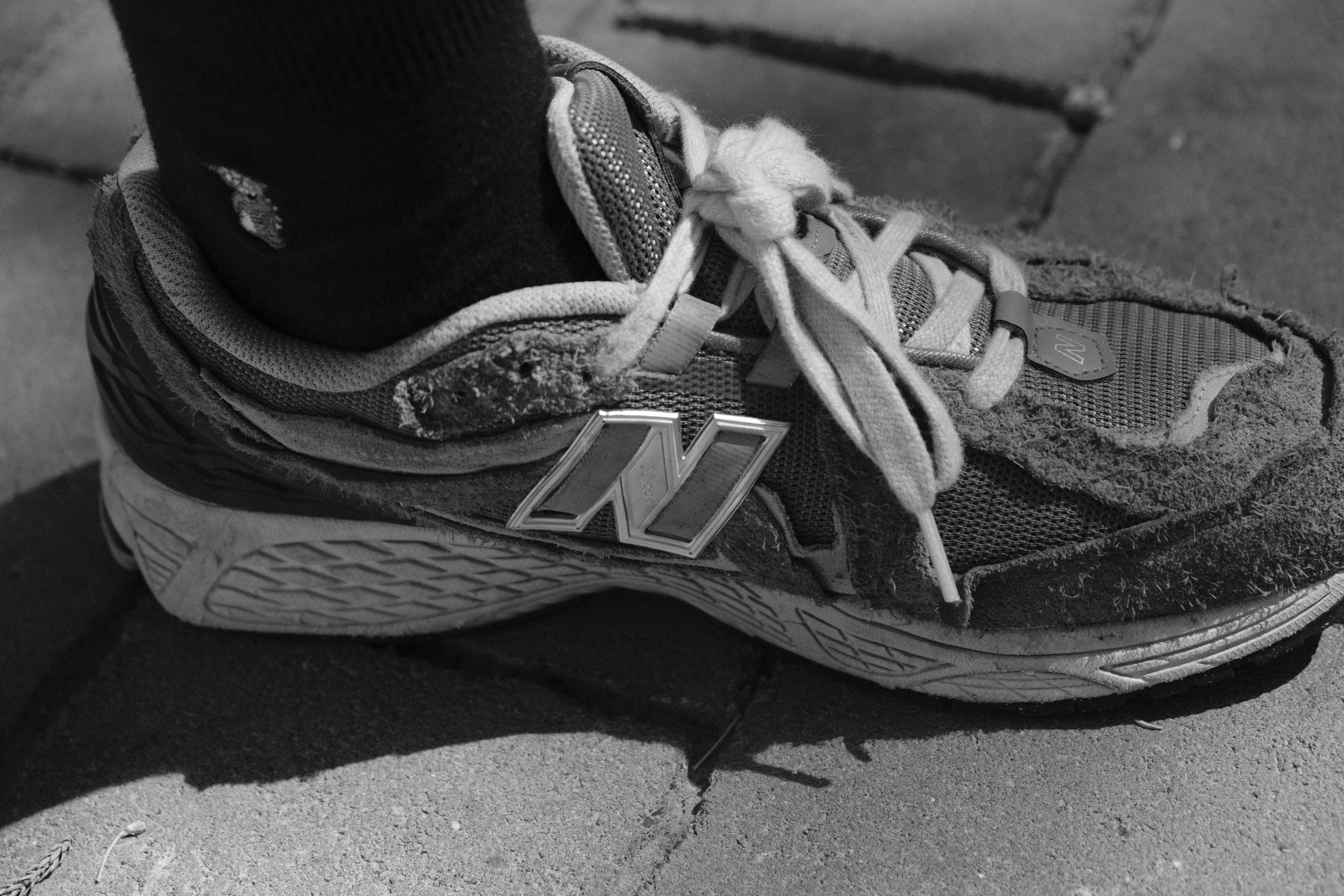 a black and white photo of a person's shoes