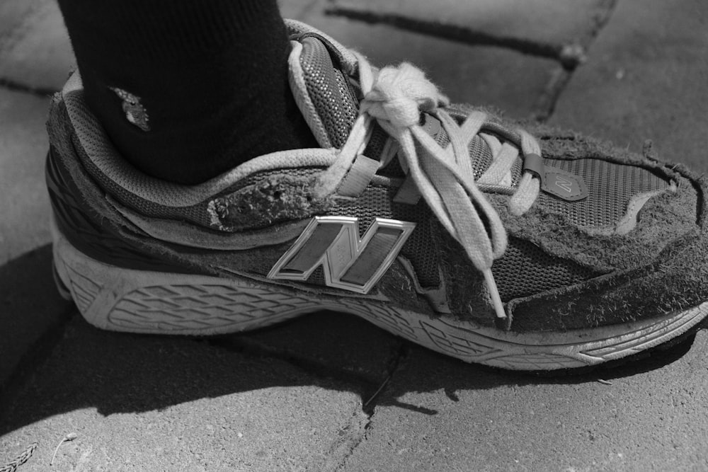 a black and white photo of a person's shoes