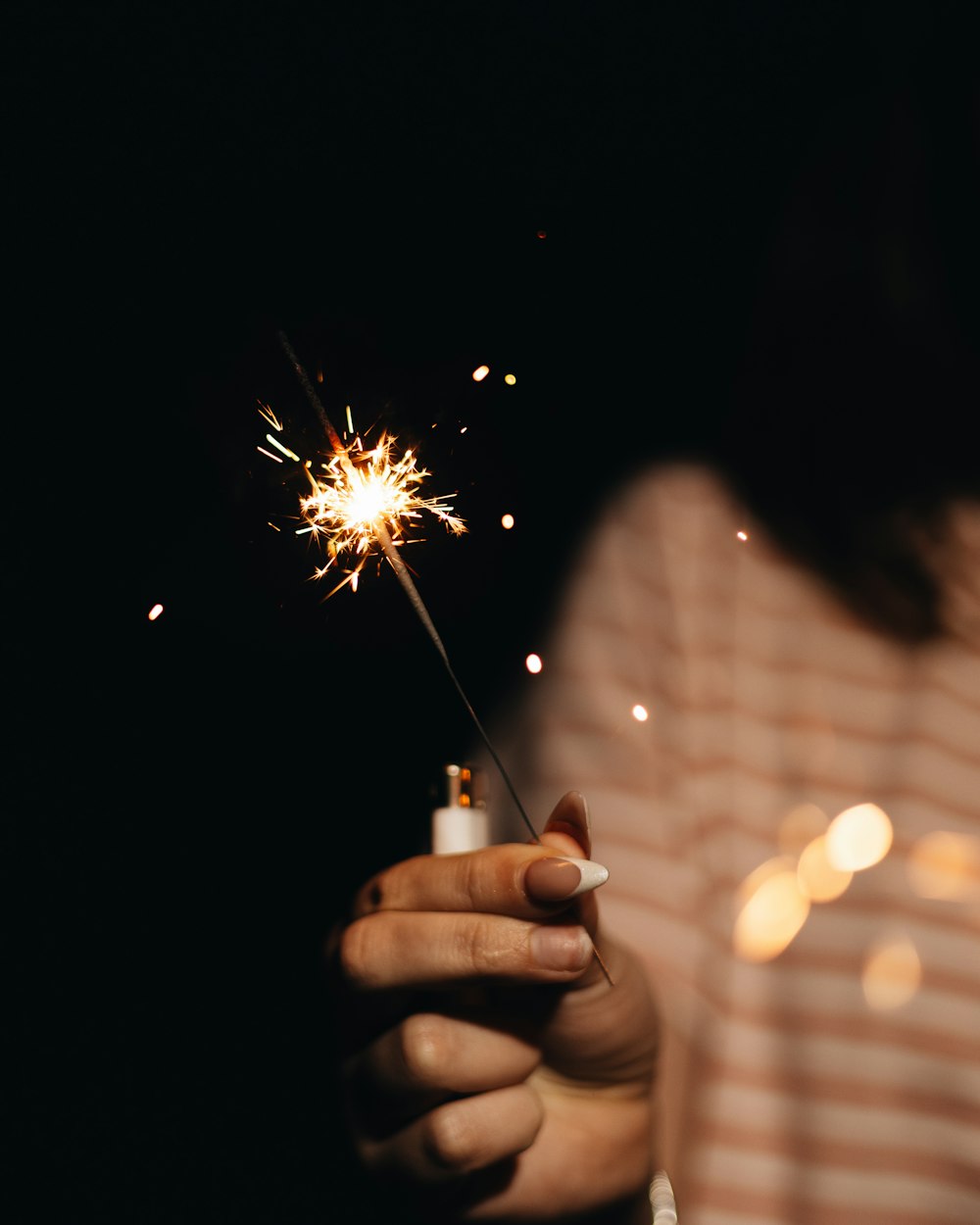 a person holding a sparkler in their hand