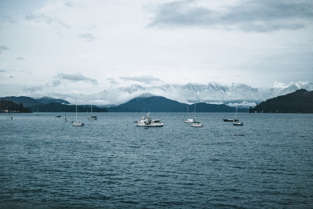 a group of boats floating on top of a large body of water