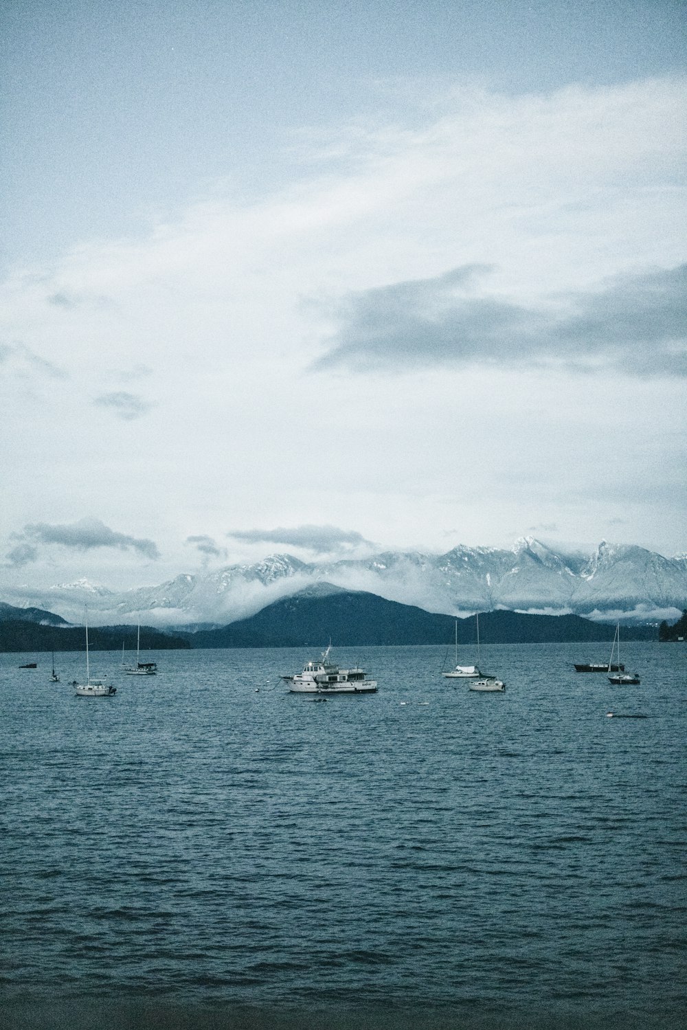 a group of boats floating on top of a large body of water