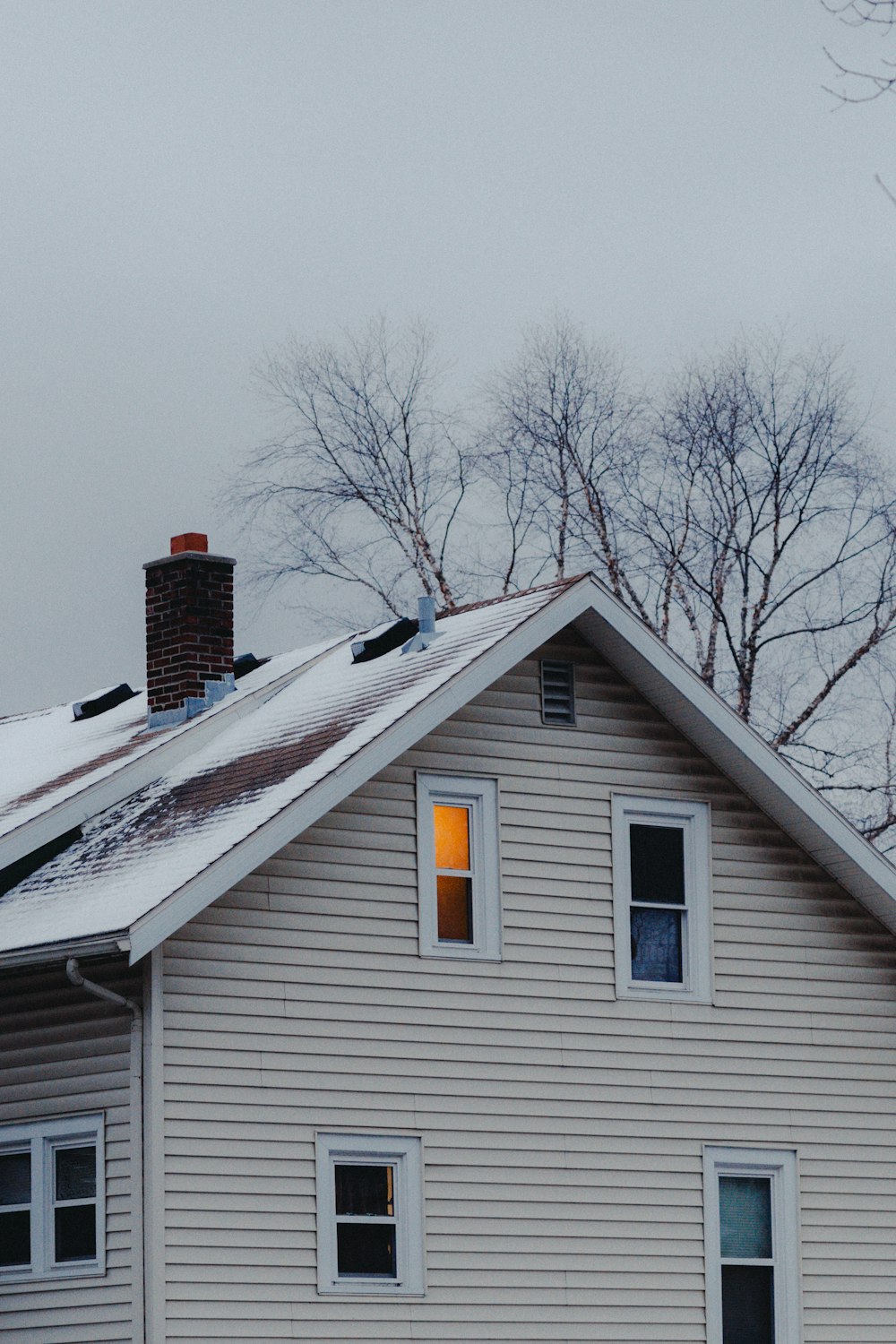 a white house with a snow covered roof