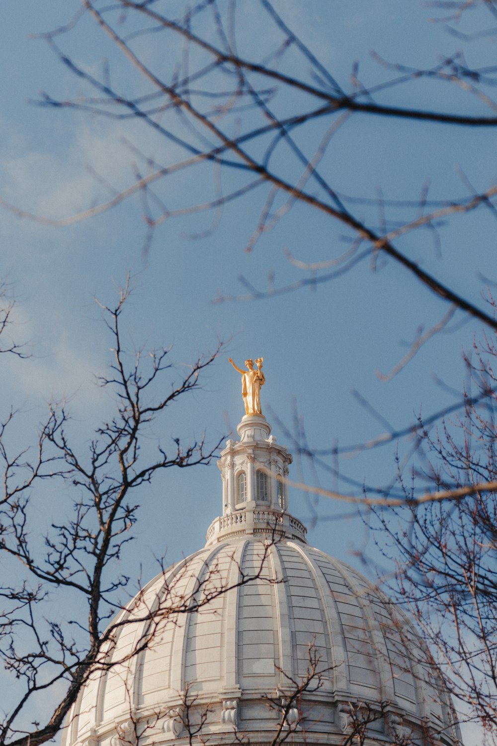 a view of the top of a building with a statue on top