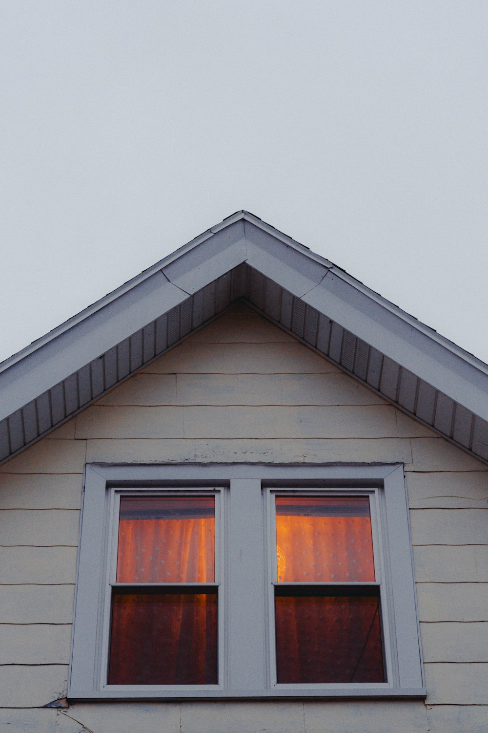 a house with two windows and a sky background