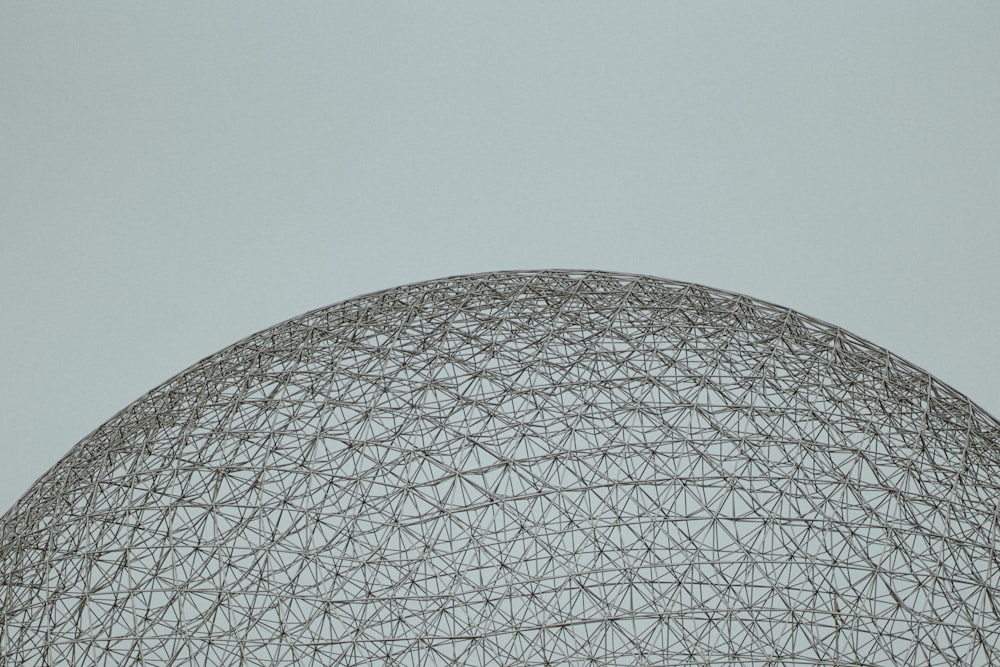 an airplane flying over a large structure in the sky