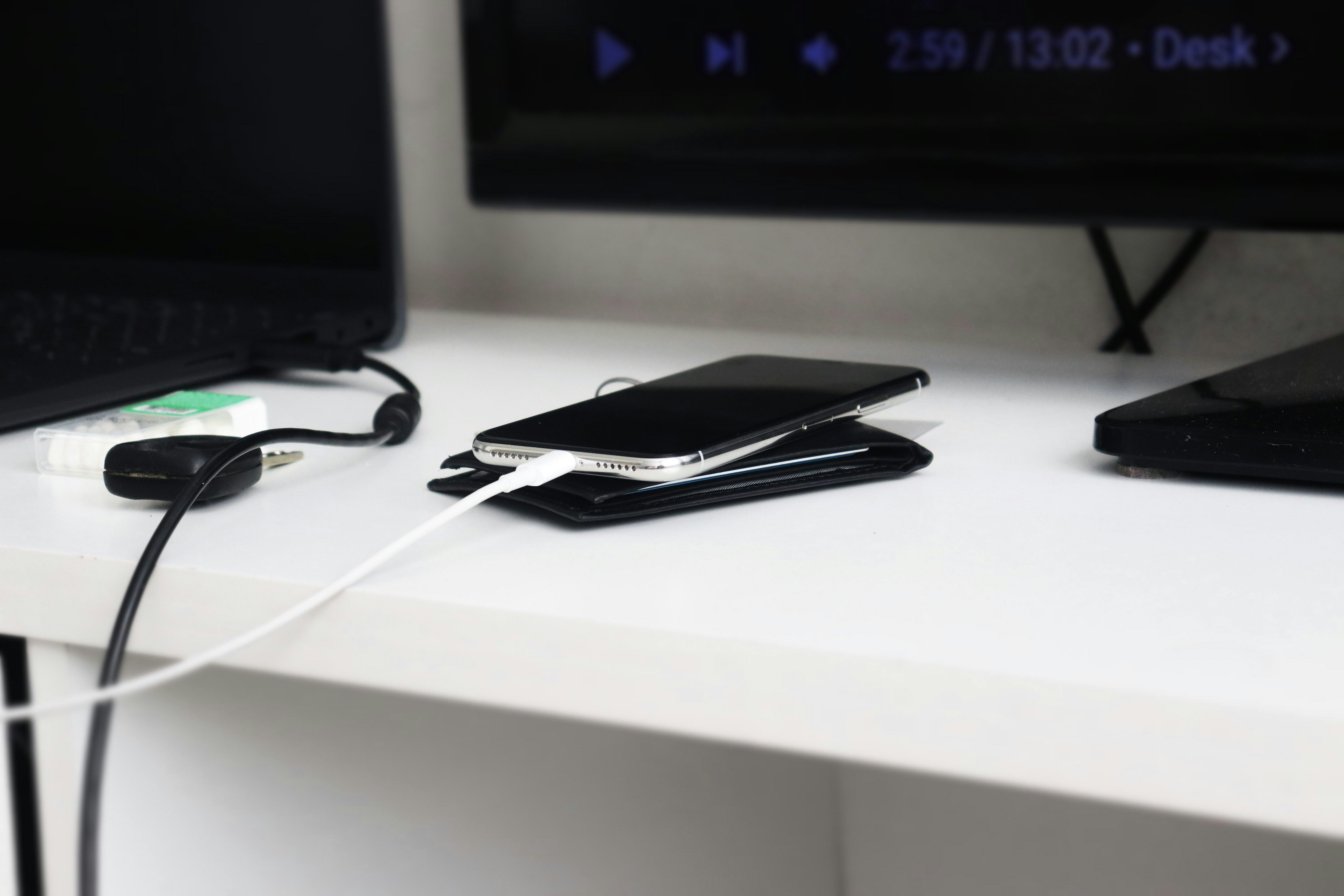modern workstation desk with android phone connected via usb-c cable to laptop running command terminal