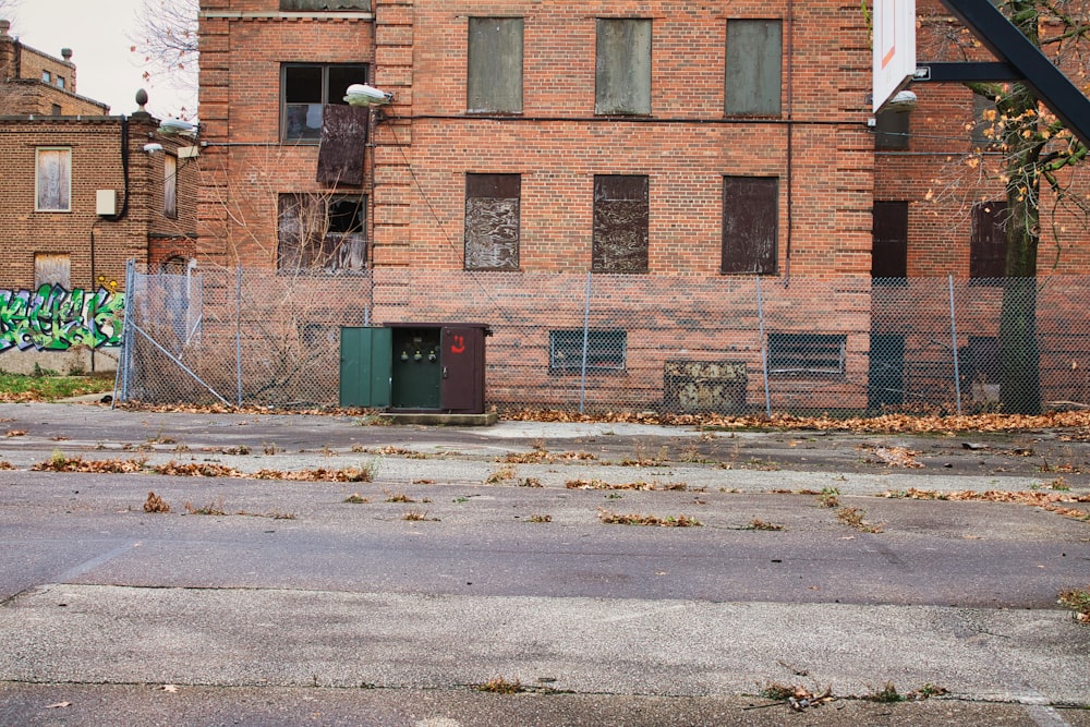 an empty parking lot in front of a brick building