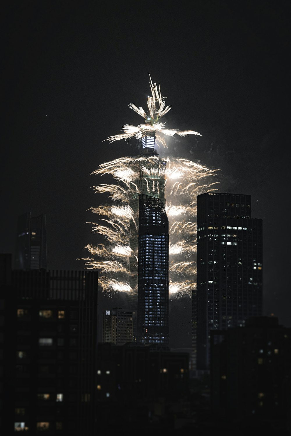 fireworks are lit up the night sky above a city
