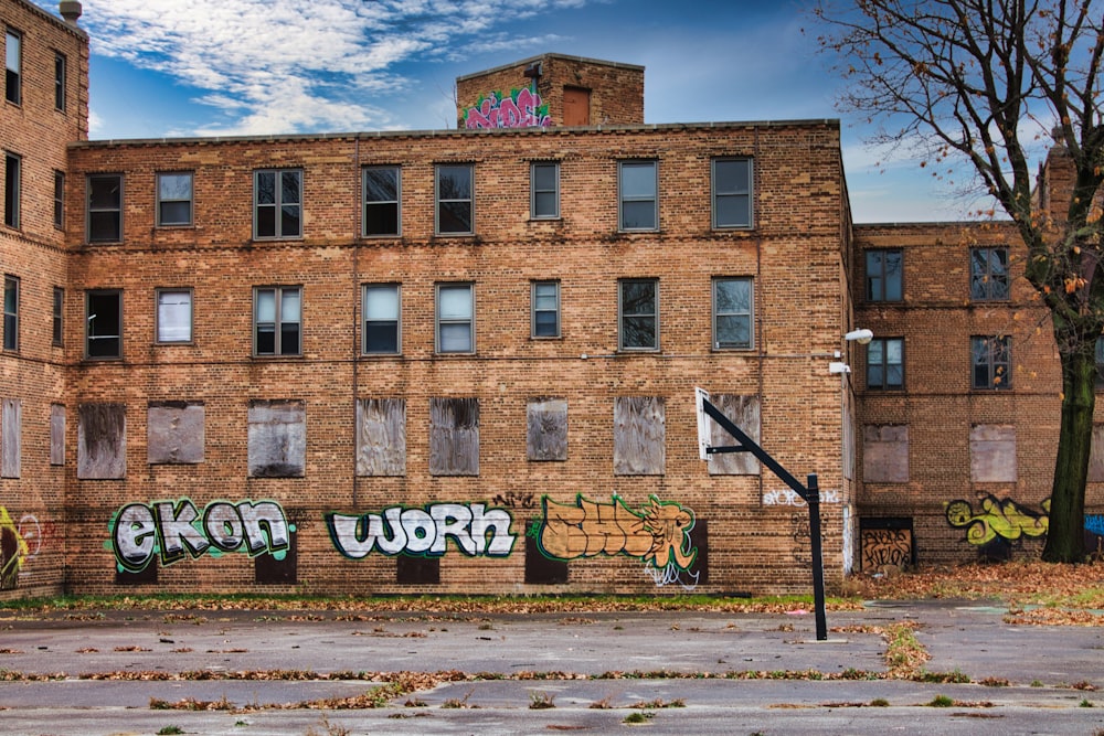 a brick building with graffiti on the side of it