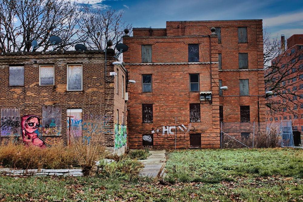 a brick building with graffiti on the side of it