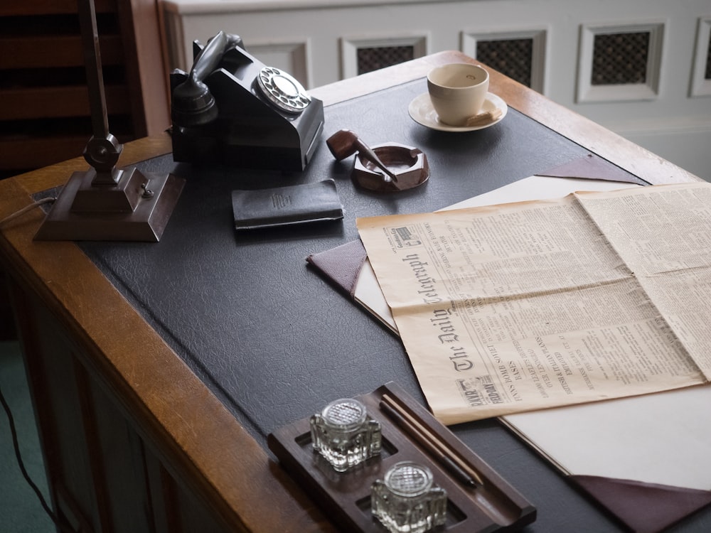 a table topped with papers and a camera