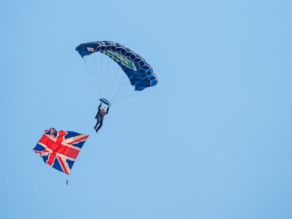 two people are parasailing in the blue sky