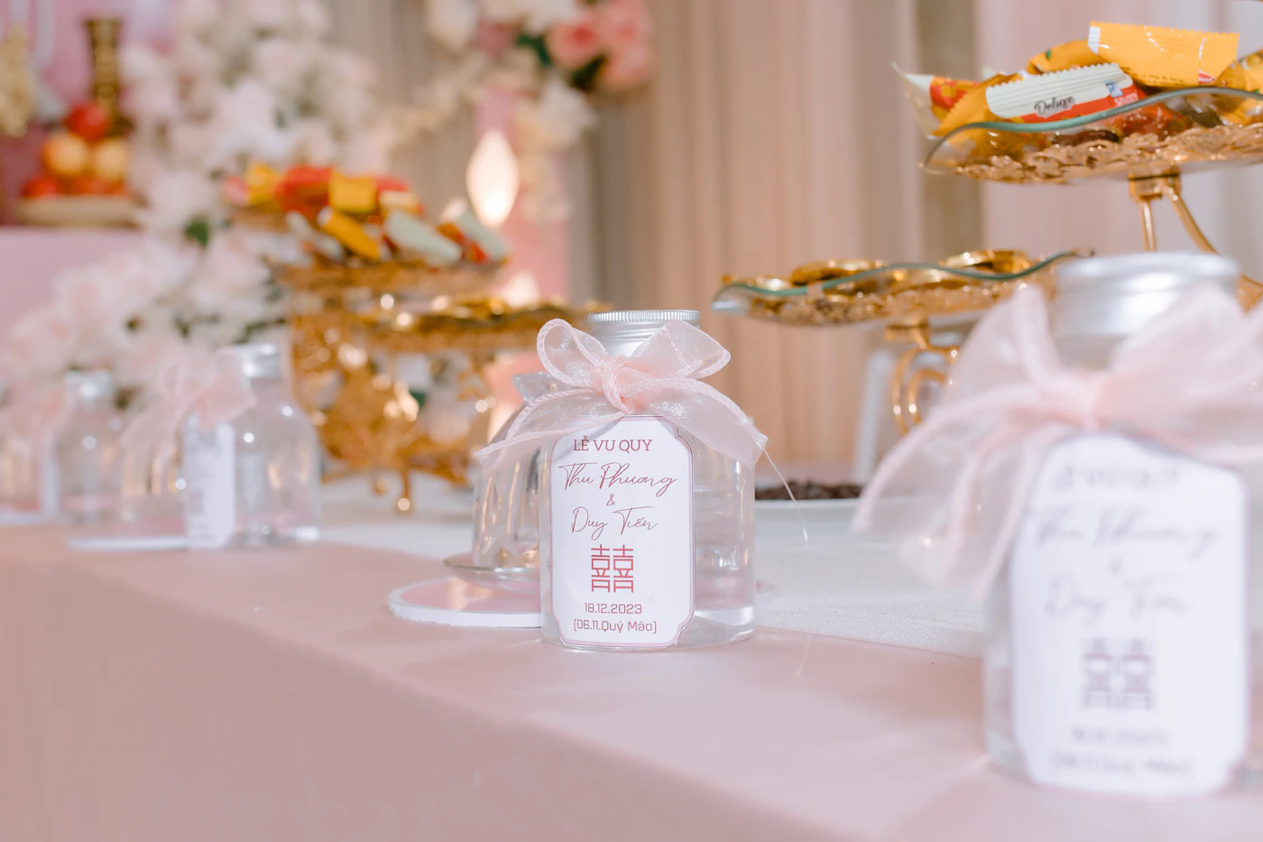 Inexpensive wedding favors guests will love — Pastel Jordan almonds fill small organza bags as wedding favors for guests.