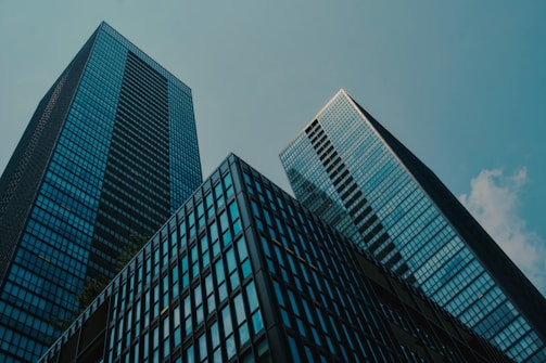 a couple of tall buildings sitting next to each other