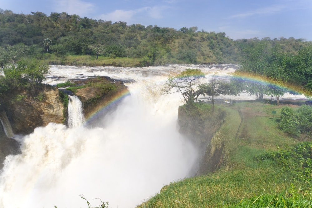 a waterfall with a rainbow in the middle of it