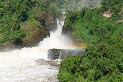a waterfall with a rainbow in the middle of it