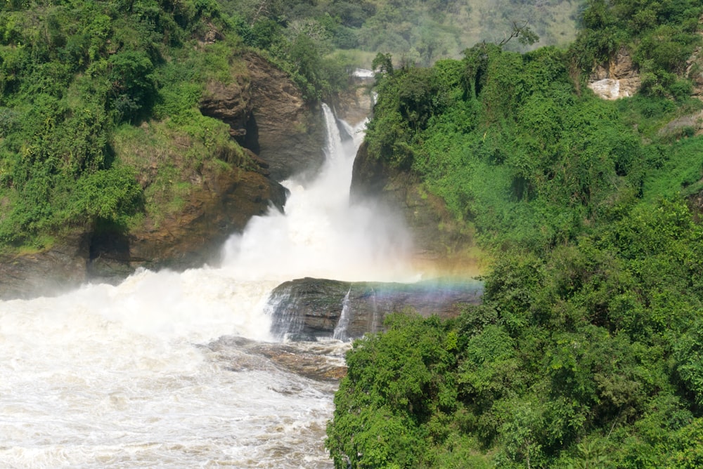 a waterfall with a rainbow in the middle of it