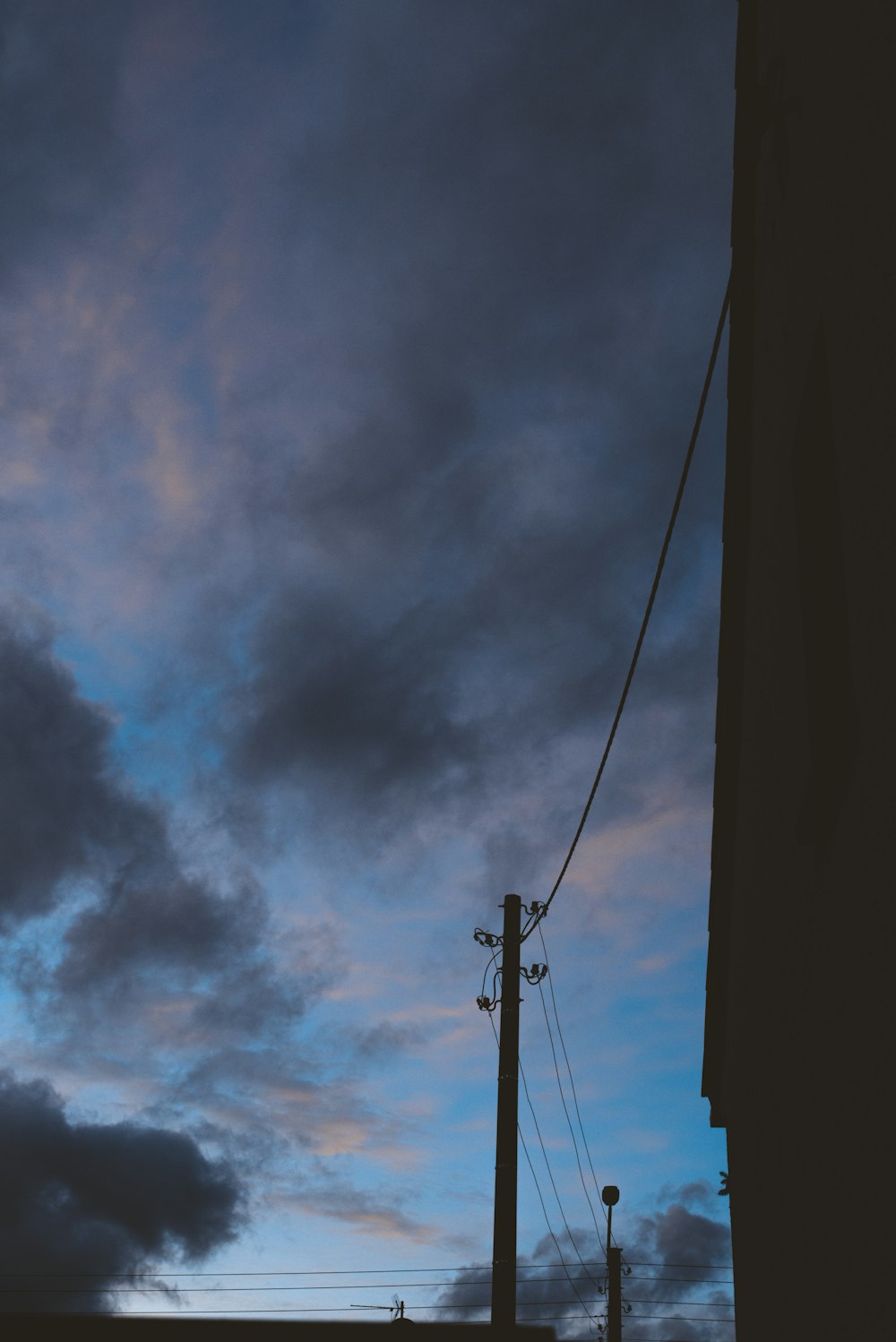 a telephone pole with a sky in the background