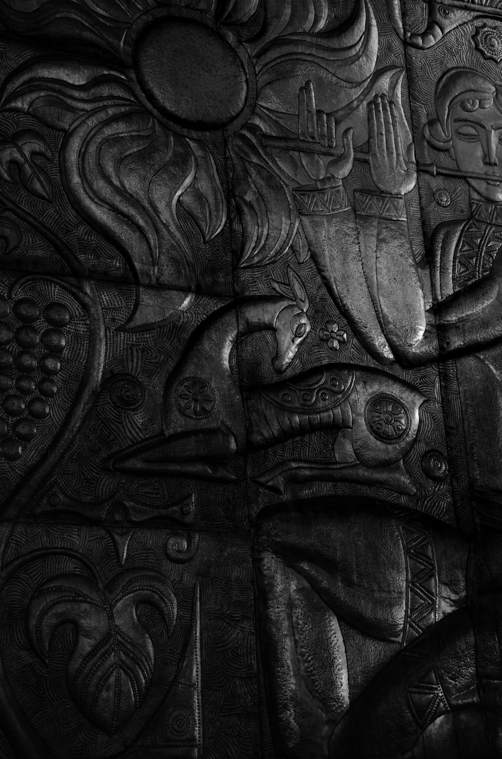 a black and white photo of a carved wall