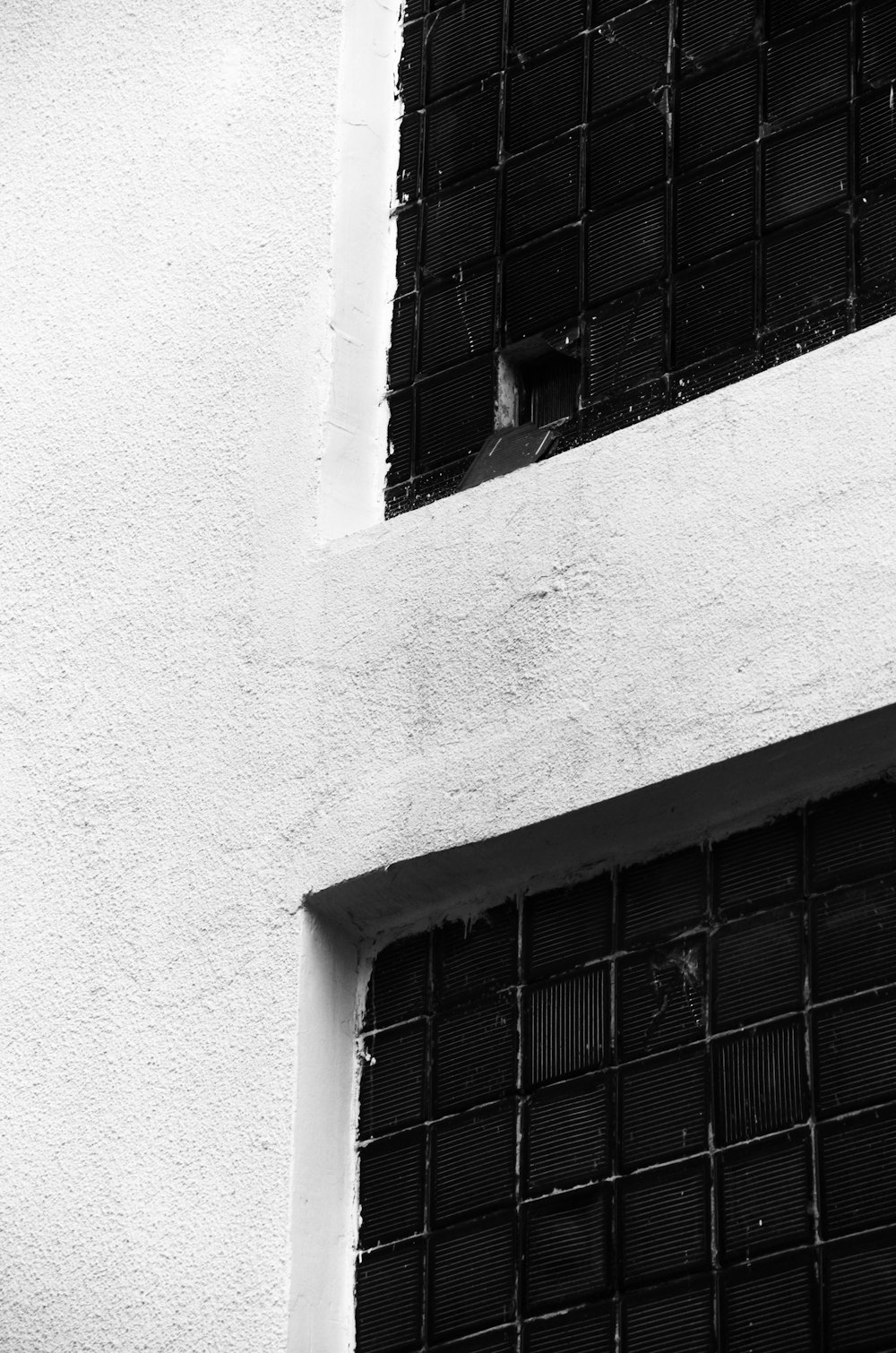 a black and white photo of a window on a building