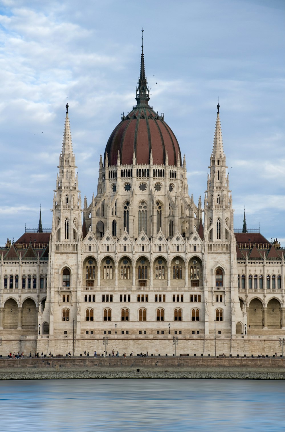 a large building with a dome on top next to a body of water