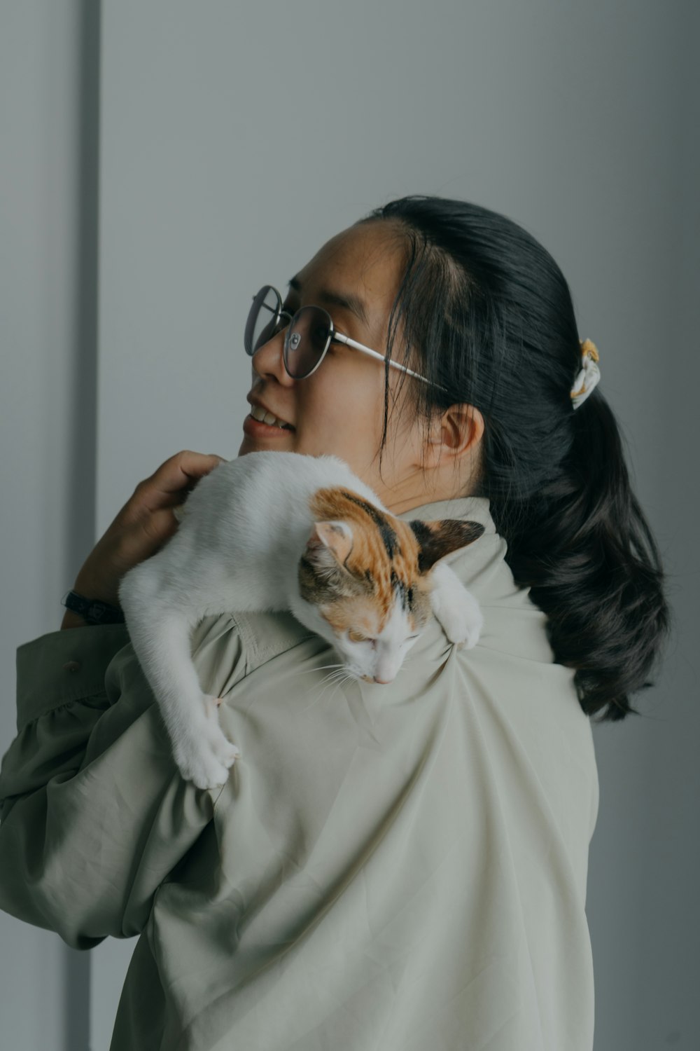 a woman holding a cat in her arms