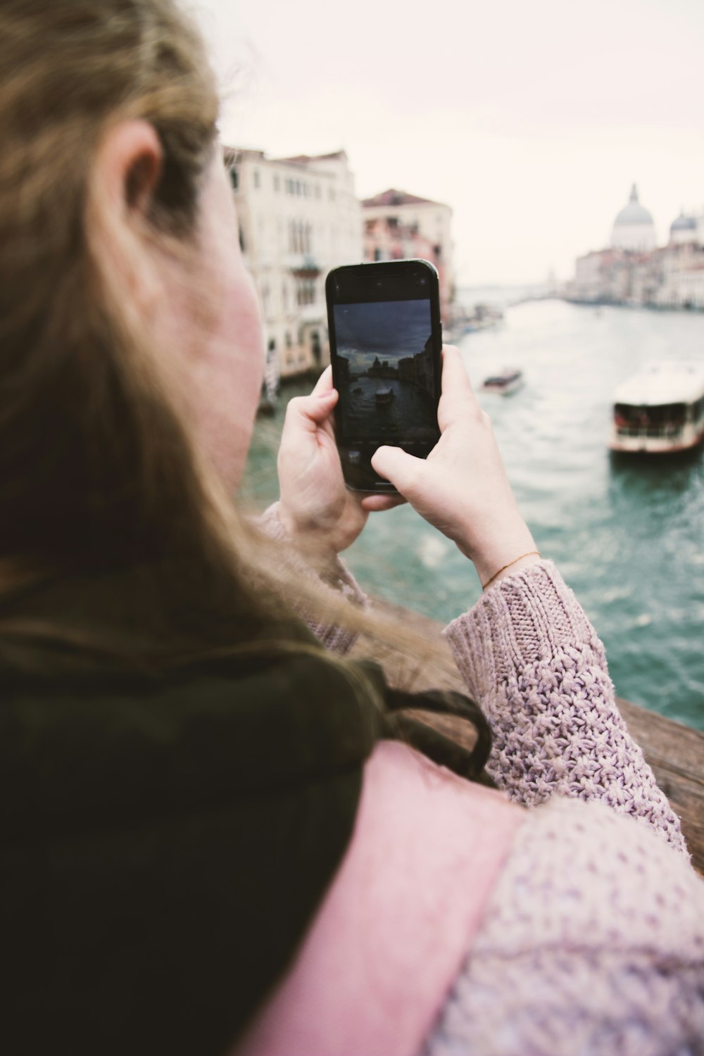 a woman is looking at her cell phone