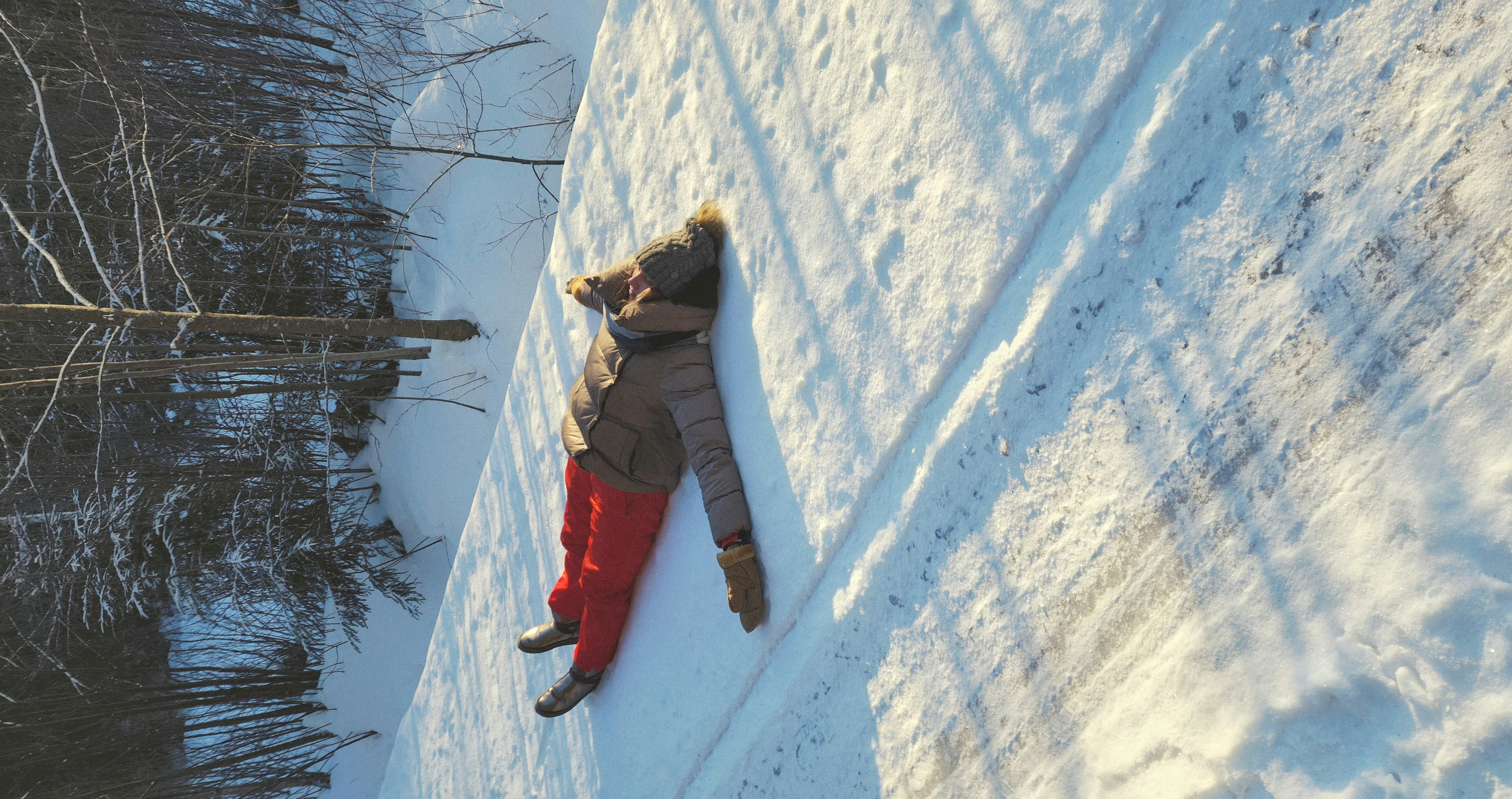 A woman is laying down in the snow photo – Free Human Image on Unsplash