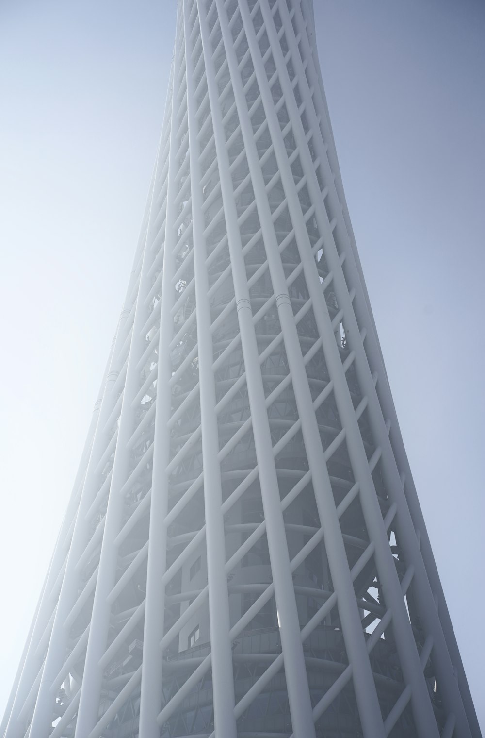 a tall white building with a sky background