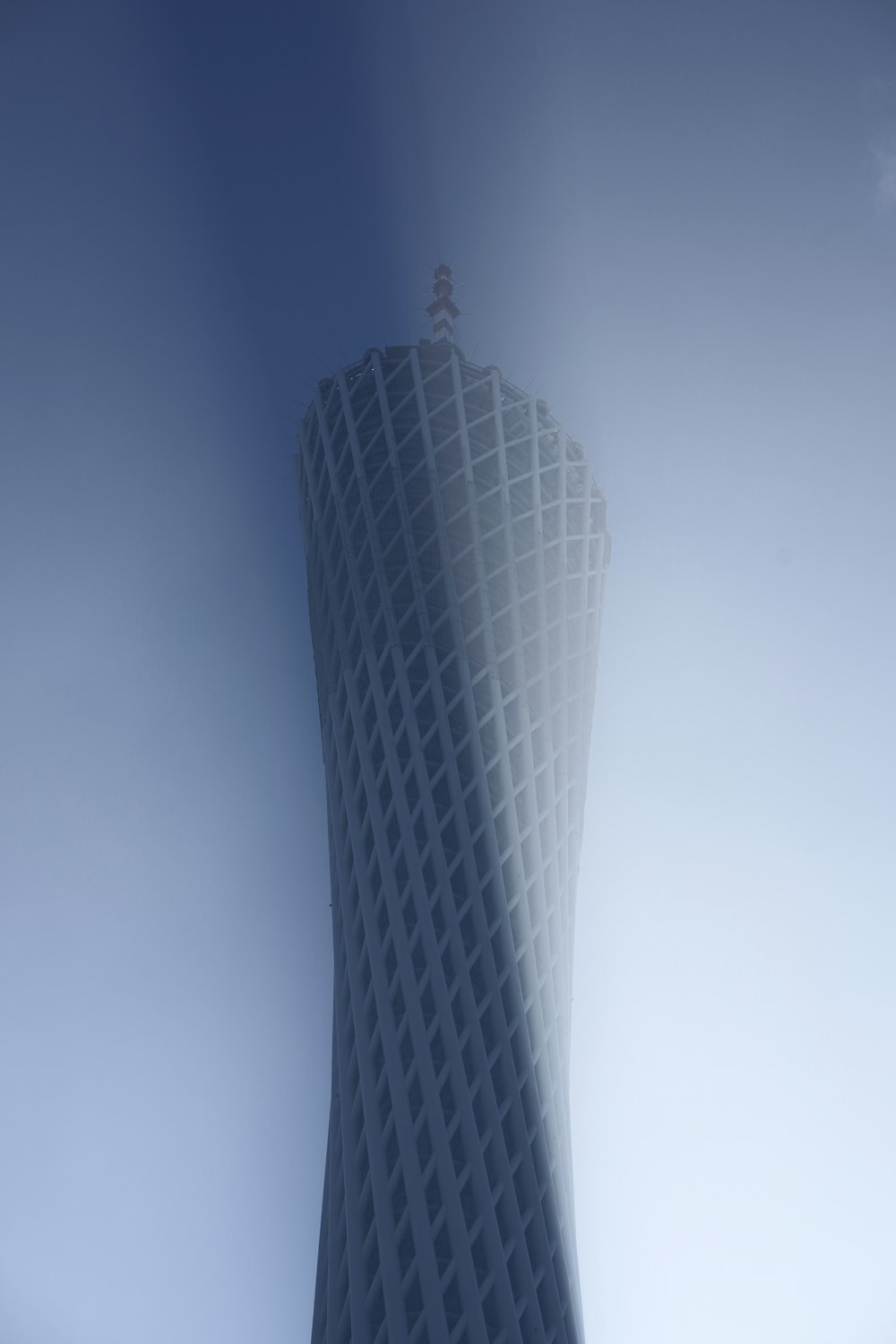 a tall white building with a sky background