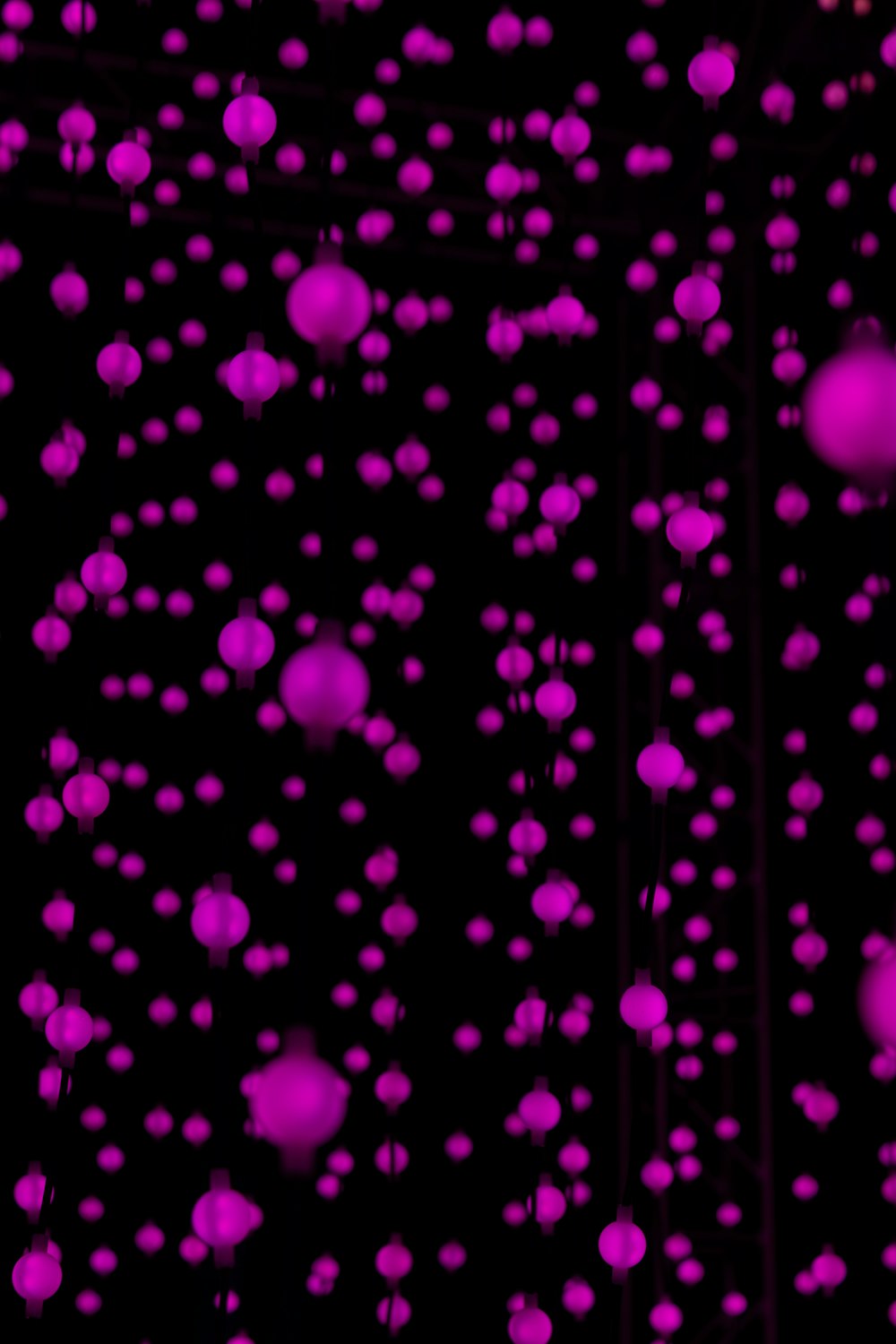 a bunch of pink balls floating in the air