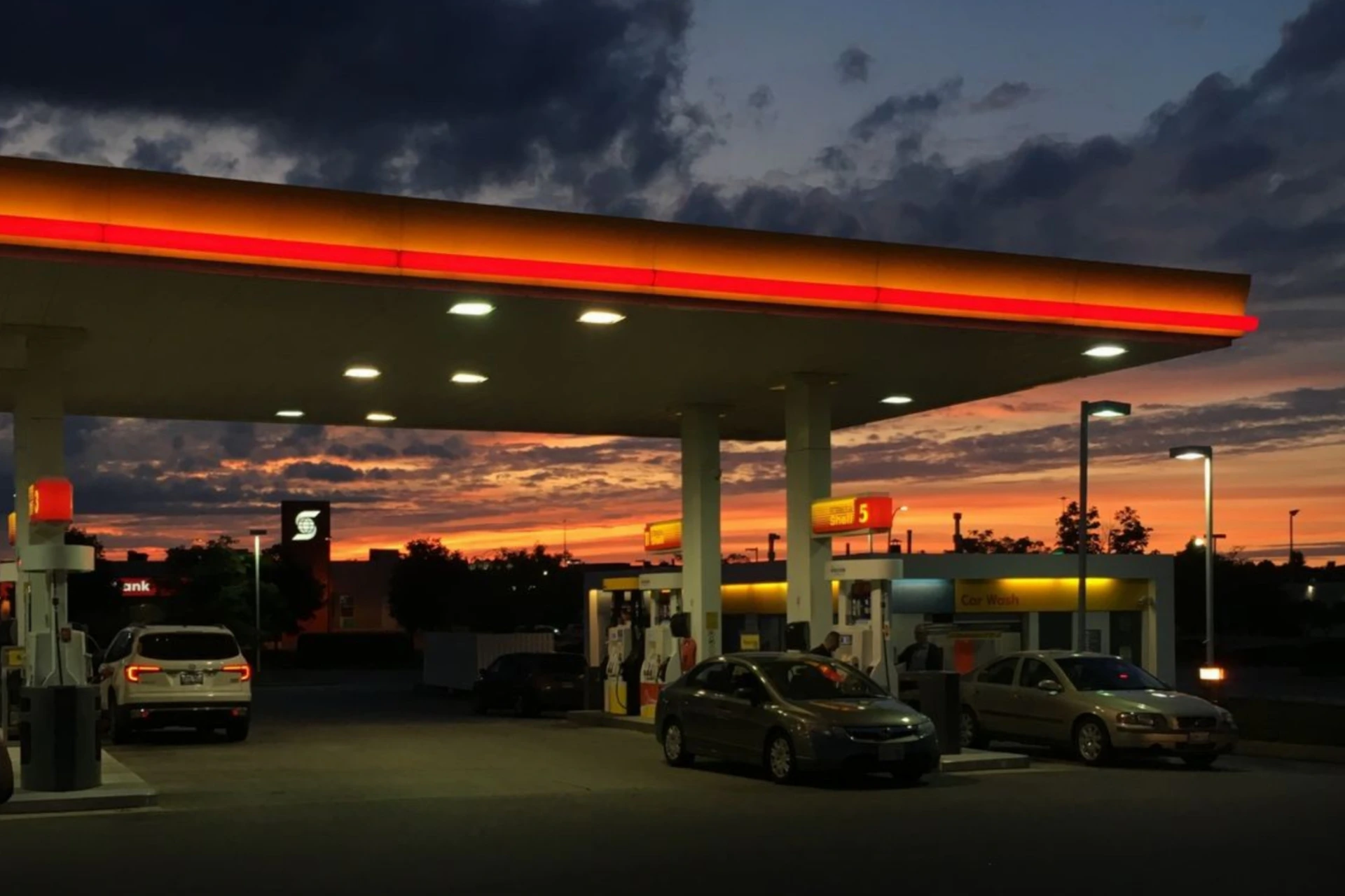 a gas station with cars parked in front of it