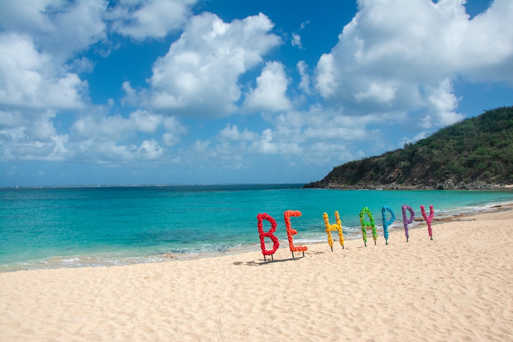 a beach with a sign that says be happy