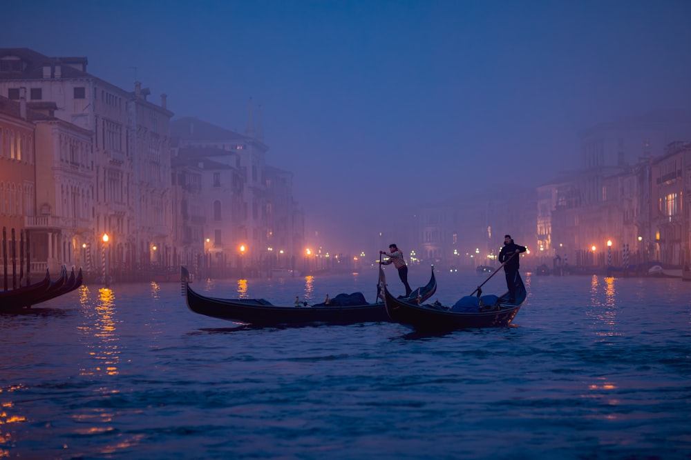 a couple of gondolas that are sitting in the water