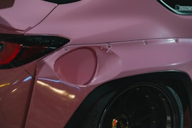 a close up of a pink sports car