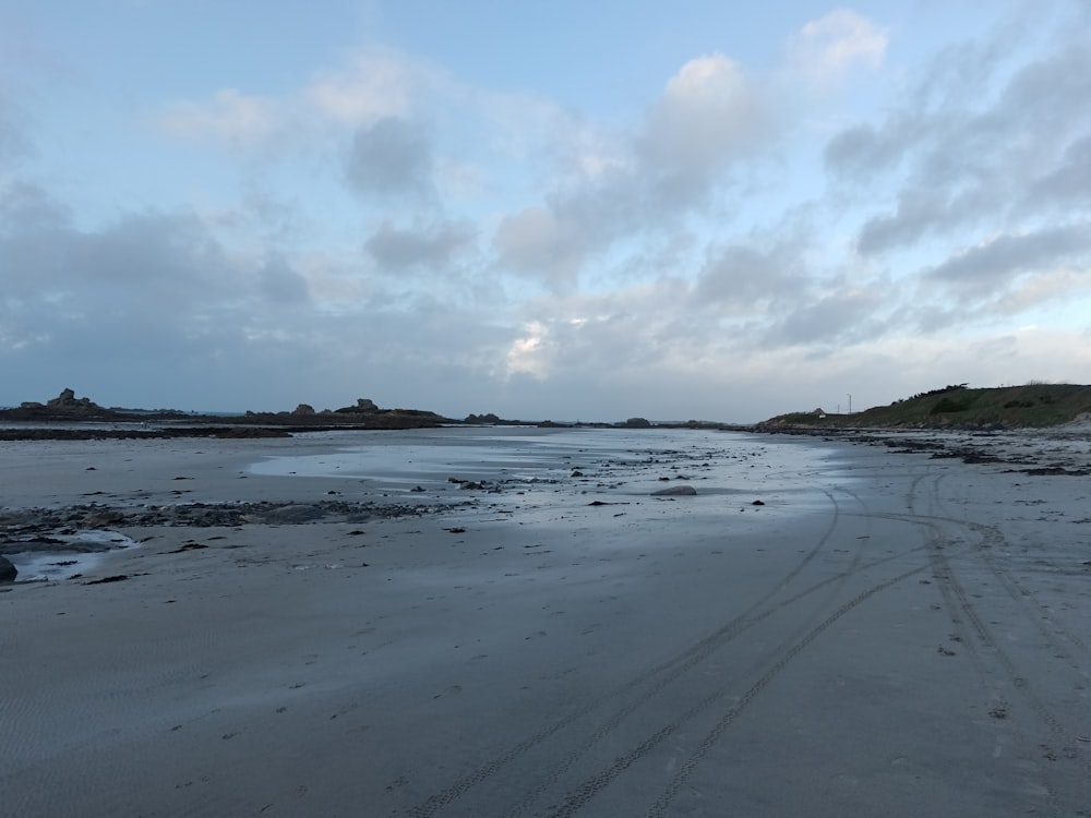 a sandy beach with footprints in the sand