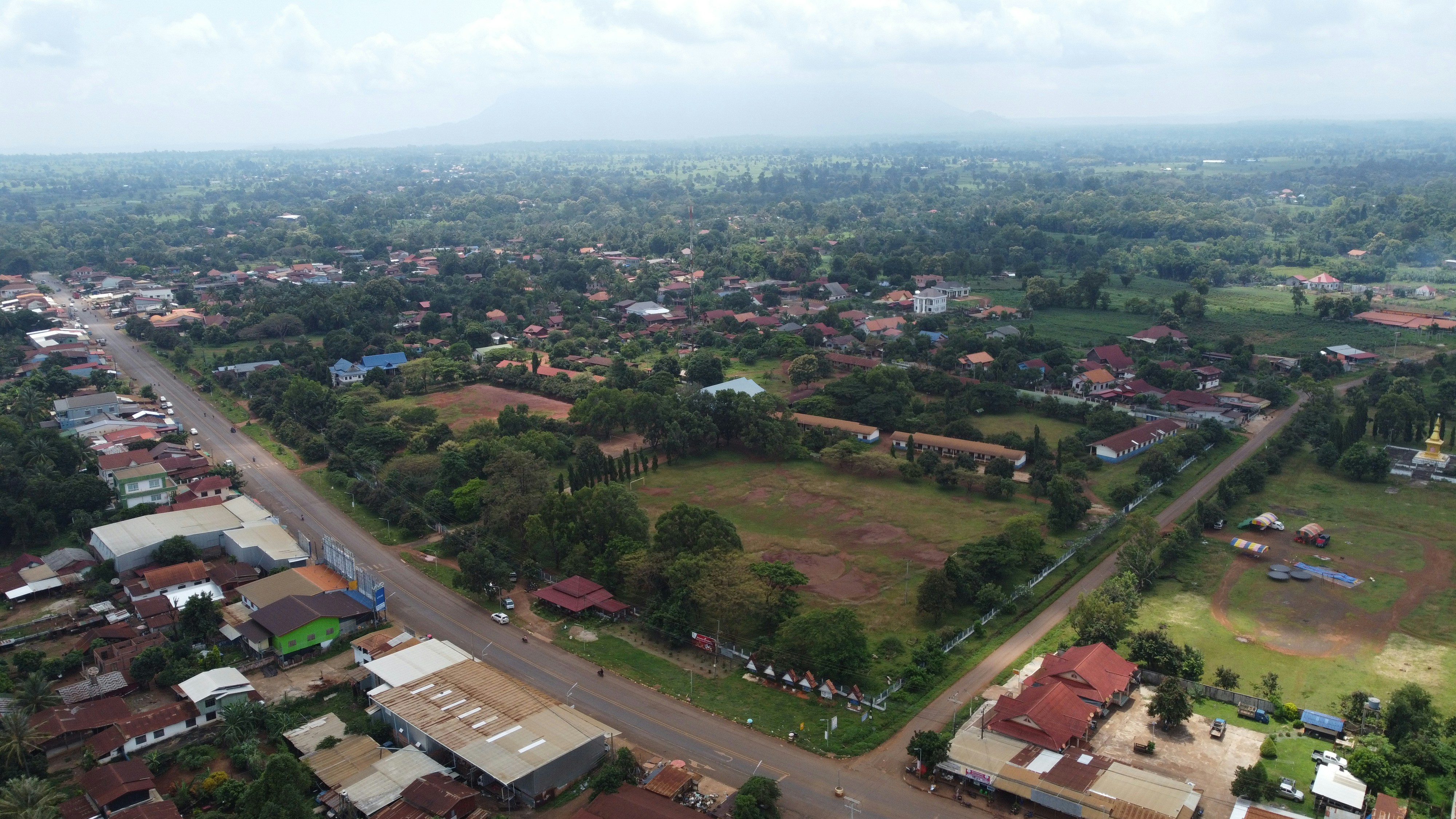 an aerial view of a small town with lots of trees