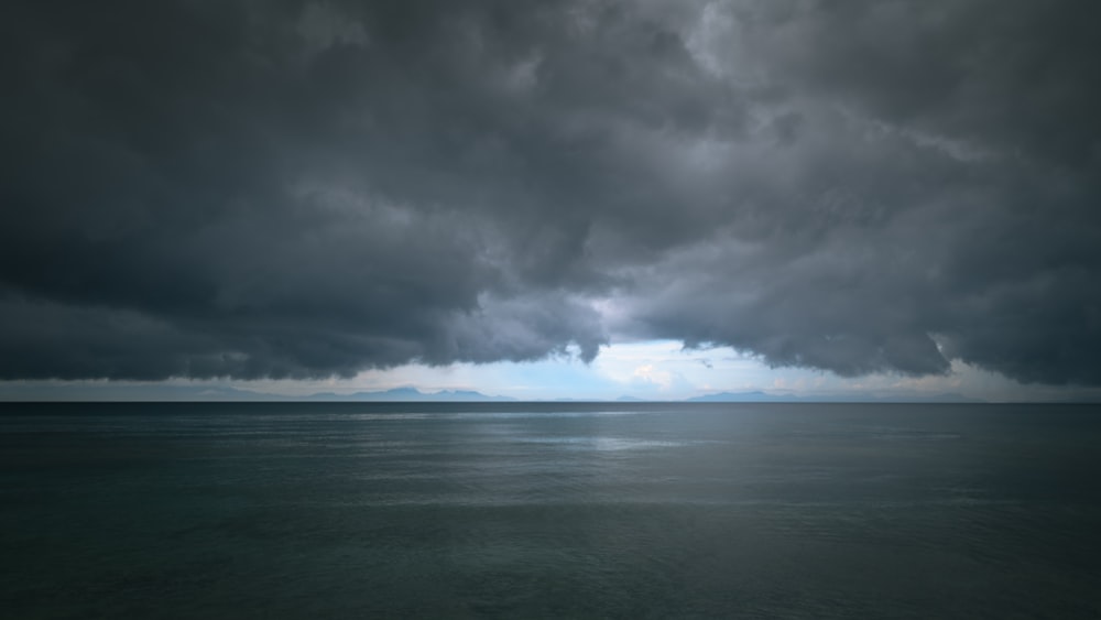 a large body of water under a cloudy sky