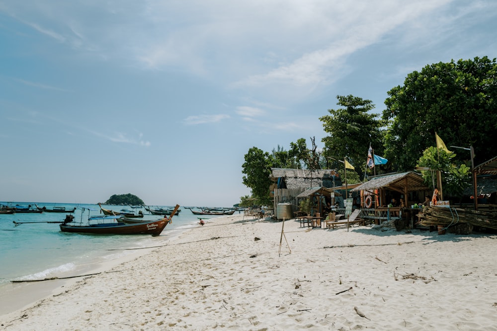 a beach with boats and people on it