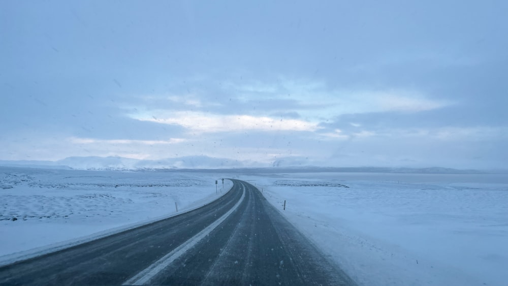 a car driving down a snow covered road