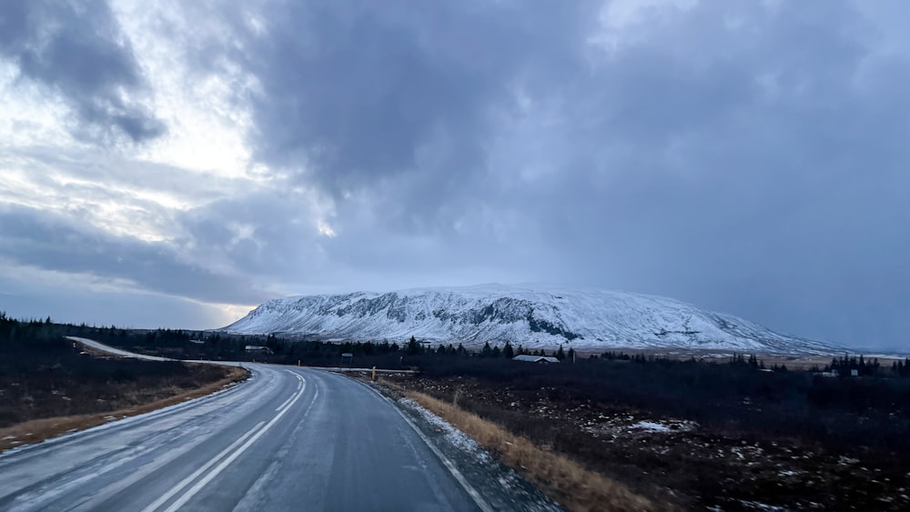 a road with a mountain in the background