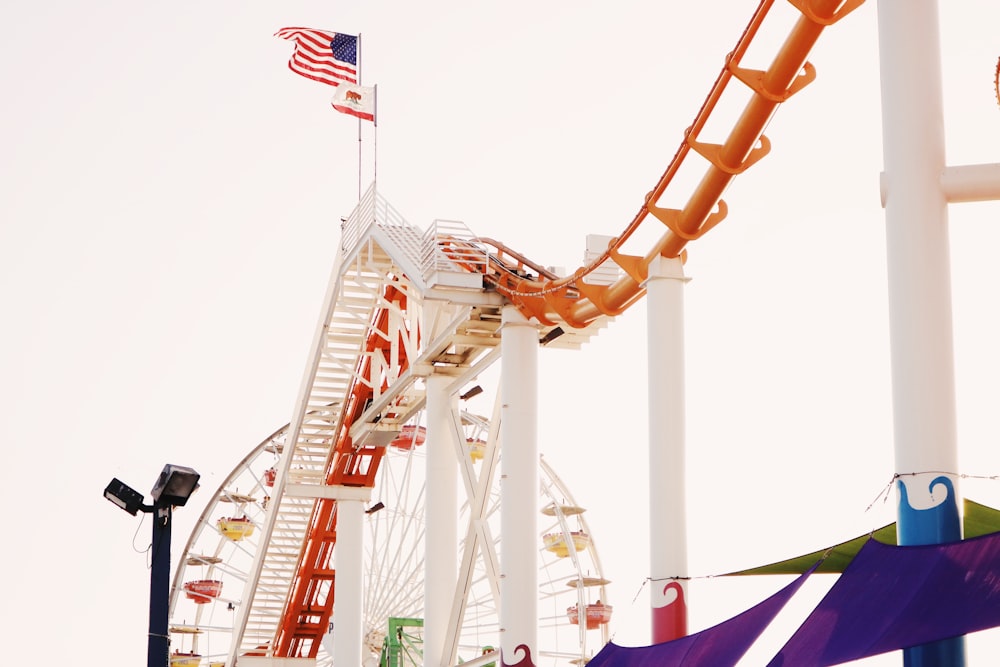 a carnival ride with a flag flying in the background